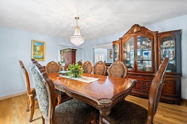 361 Locust Pl, Freeport, NY 11520 - dining room with a chandelier and light wood-style floors