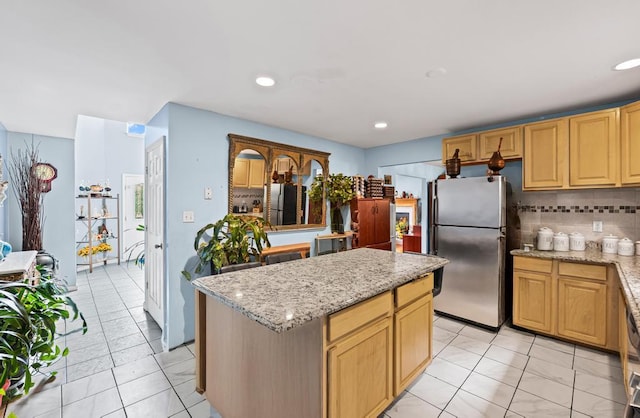 361 Locust Pl, Freeport, NY 11520 - kitchen with freestanding refrigerator, backsplash, a kitchen island, light stone countertops, and recessed lighting