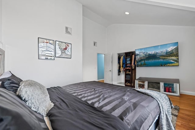 361 Locust Pl, Freeport, NY 11520 - bedroom with wood finished floors and high vaulted ceiling