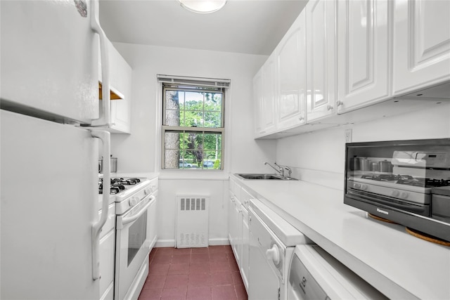 69-29 210th St Unit A, Bayside, NY 11364 - kitchen featuring white appliances, a sink, radiator, white cabinets, and dark tile patterned floors