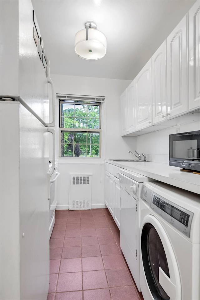 69-29 210th St Unit A, Bayside, NY 11364 - laundry room with radiator heating unit, independent washer and dryer, a sink, and baseboards