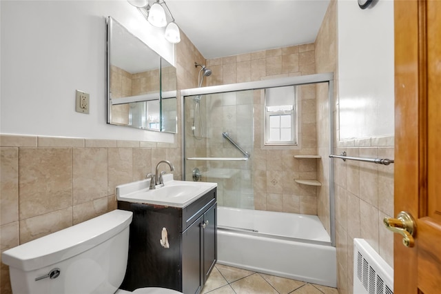 69-29 210th St Unit A, Bayside, NY 11364 - bathroom featuring tile walls, toilet, vanity, shower / bath combination with glass door, and tile patterned flooring