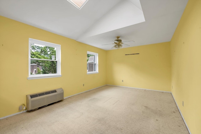 1337 Broadway Unit D20, Hewlett, NY 11557 - unfurnished room featuring a wall mounted AC, carpet flooring, lofted ceiling, a skylight, and ceiling fan