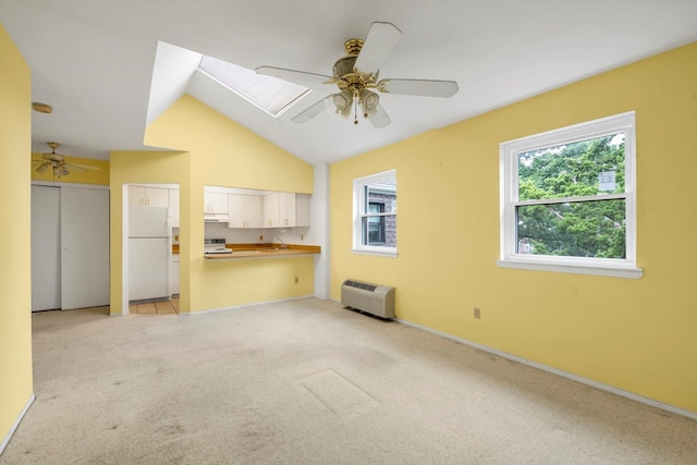 1337 Broadway Unit D20, Hewlett, NY 11557 - unfurnished living room featuring ceiling fan, light carpet, and vaulted ceiling