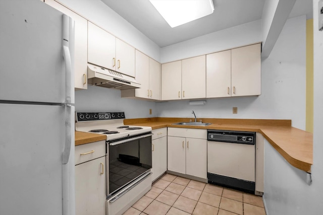 1337 Broadway Unit D20, Hewlett, NY 11557 - kitchen featuring white appliances, under cabinet range hood, light countertops, and light tile patterned floors