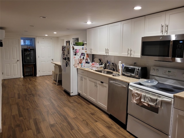 3039 Fulton St, Brooklyn, NY 11208 - kitchen with appliances with stainless steel finishes, white cabinetry, dark wood-style flooring, and recessed lighting