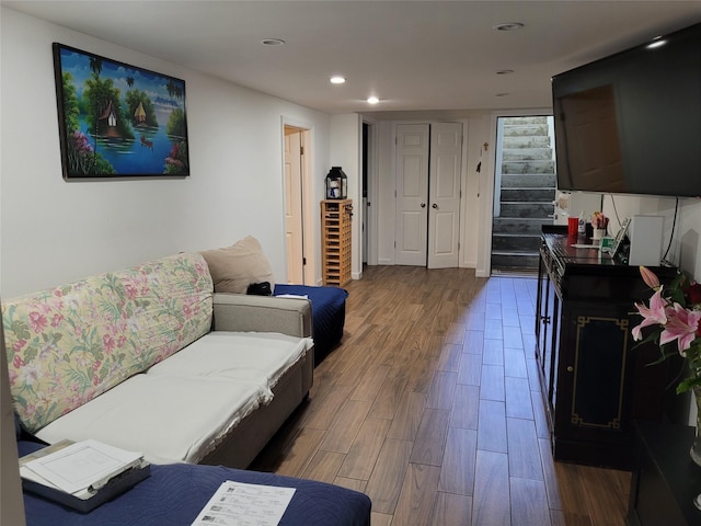 3039 Fulton St, Brooklyn, NY 11208 - living area with wood finished floors, stairs, and recessed lighting