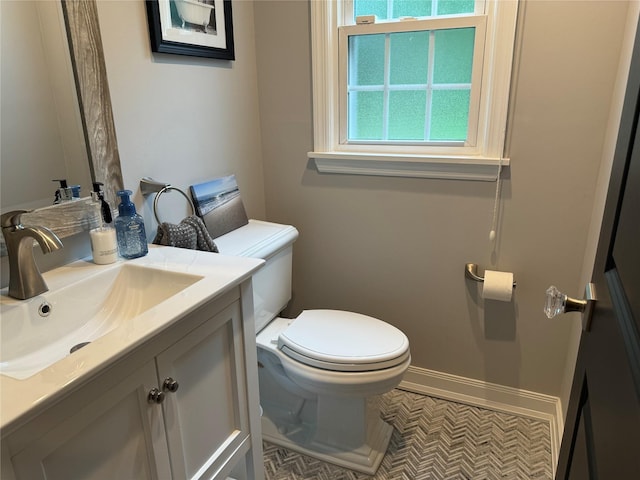 7 Yorkshire Ave, Stony Brook, NY 11790 - half bathroom featuring toilet, vanity, and baseboards