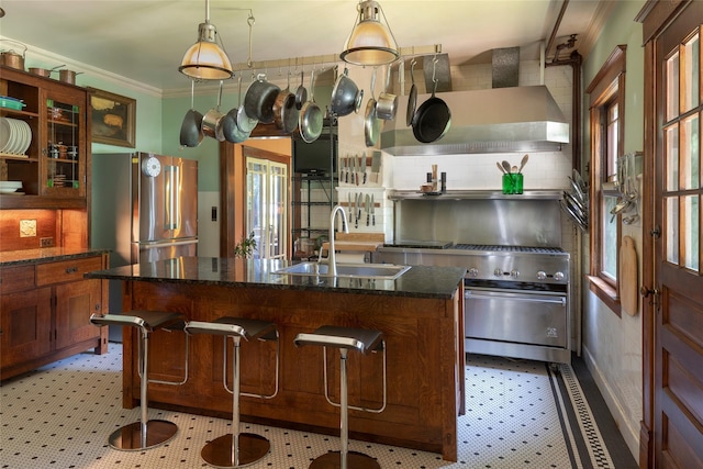 8 Elmer Galloway Rd, Katonah, NY 10536 - kitchen with appliances with stainless steel finishes, wall chimney exhaust hood, ornamental molding, backsplash, and a center island with sink