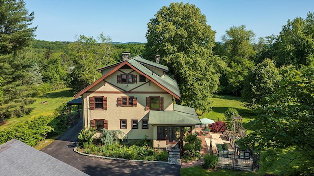 8 Elmer Galloway Rd, Katonah, NY 10536 - view of front of home featuring a chimney, stucco siding, and a view of trees