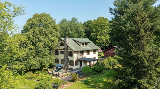 8 Elmer Galloway Rd, Katonah, NY 10536 - rear view of house with a chimney, stucco siding, and a yard