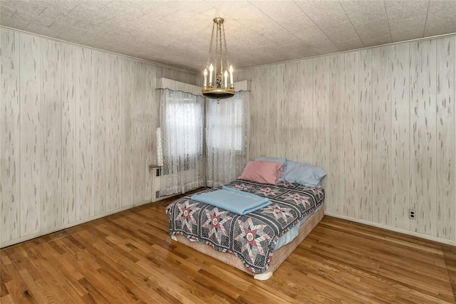 200-16 42nd Ave, Bayside, NY 11361 - bedroom with wood finished floors, baseboards, and wooden walls