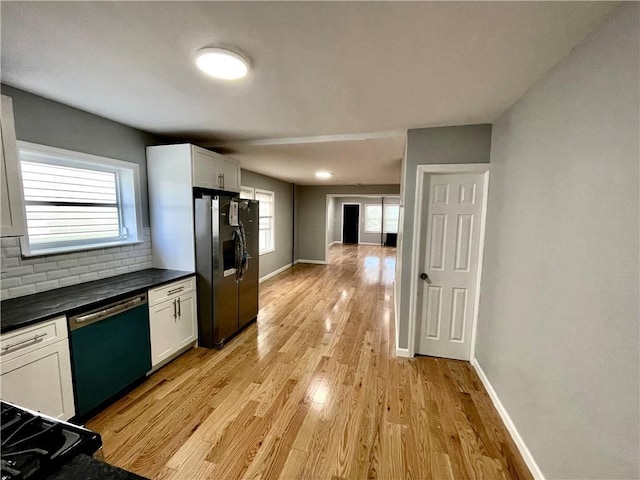 1231 E 88th St, Brooklyn, NY 11236 - kitchen with fridge with ice dispenser, dishwashing machine, tasteful backsplash, dark countertops, and baseboards