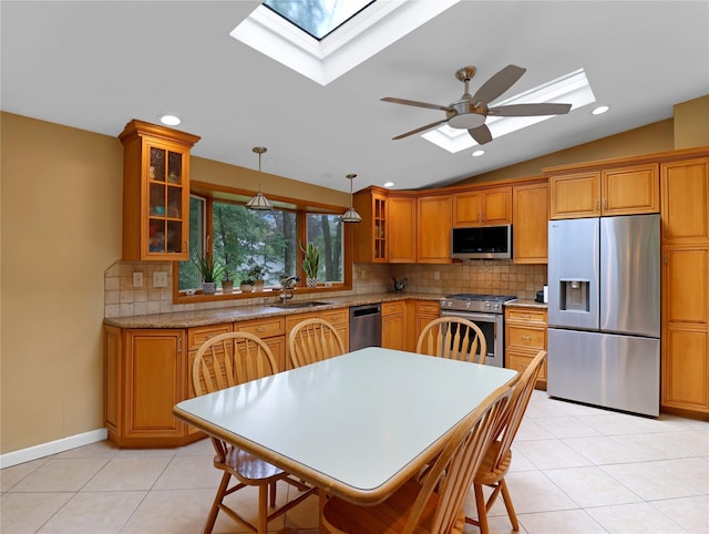 2 Hedge Row, New City, NY 10956 - kitchen featuring appliances with stainless steel finishes, a skylight, lofted ceiling, decorative backsplash, and a ceiling fan