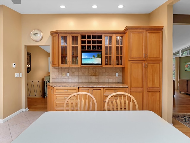 2 Hedge Row, New City, NY 10956 - kitchen featuring backsplash, glass insert cabinets, light tile patterned flooring, brown cabinetry, and recessed lighting