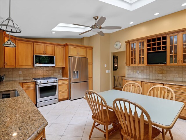 2 Hedge Row, New City, NY 10956 - kitchen featuring stainless steel appliances, a skylight, tasteful backsplash, ceiling fan, and lofted ceiling