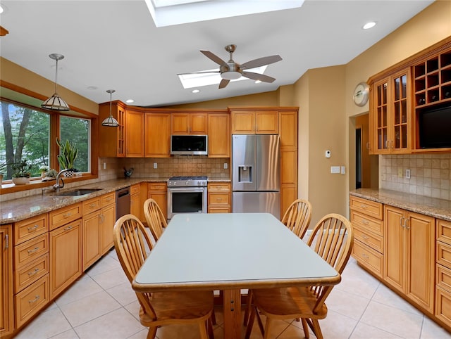 2 Hedge Row, New City, NY 10956 - kitchen with appliances with stainless steel finishes, a skylight, vaulted ceiling, light tile patterned floors, and tasteful backsplash