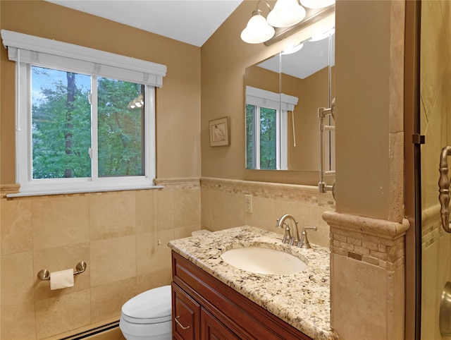 2 Hedge Row, New City, NY 10956 - bathroom with healthy amount of natural light, vanity, baseboard heating, tile walls, and wainscoting