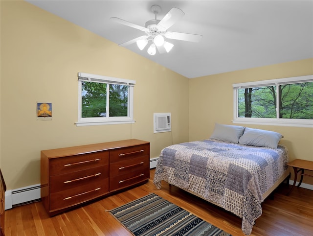 2 Hedge Row, New City, NY 10956 - bedroom featuring baseboard heating, lofted ceiling, wood finished floors, and a wall unit AC