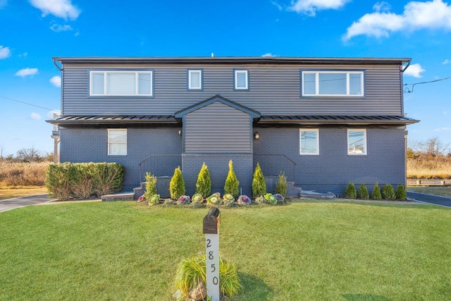 2850 Shore Rd, Seaford, NY 11783 - view of front facade with a standing seam roof, brick siding, and metal roof