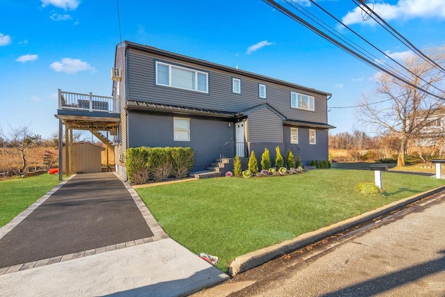 2850 Shore Rd, Seaford, NY 11783 - view of front facade featuring asphalt driveway, a front yard, and brick siding