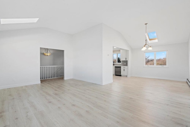 2850 Shore Rd, Seaford, NY 11783 - unfurnished living room featuring a skylight, vaulted ceiling, light wood finished floors, baseboards, and a chandelier