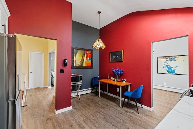 2850 Shore Rd, Seaford, NY 11783 - dining space with a baseboard radiator, light wood-style flooring, high vaulted ceiling, and baseboards