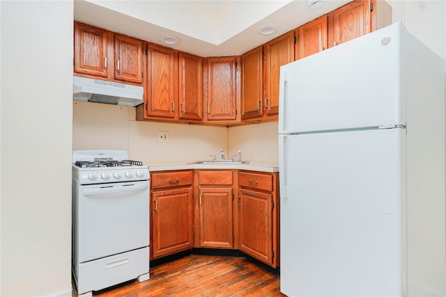 9430 Ridge Blvd Unit 6F, Brooklyn, NY 11209 - kitchen with white appliances, under cabinet range hood, light countertops, wood finished floors, and brown cabinets