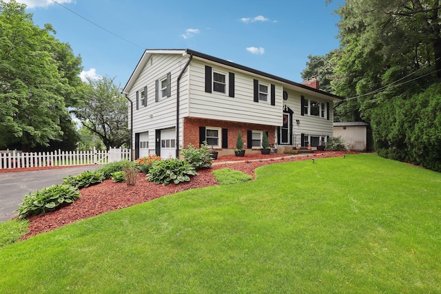 118 Standish Dr, Pearl River, NY 10965 - raised ranch featuring brick siding, a chimney, asphalt driveway, and an attached garage