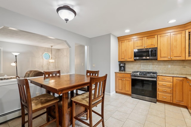 118 Standish Dr, Pearl River, NY 10965 - kitchen with appliances with stainless steel finishes, a baseboard radiator, backsplash, light stone countertops, and light tile patterned floors