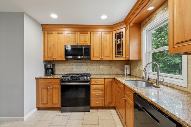 118 Standish Dr, Pearl River, NY 10965 - kitchen featuring stainless steel appliances, light stone counters, tasteful backsplash, glass insert cabinets, and brown cabinetry