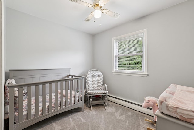 118 Standish Dr, Pearl River, NY 10965 - bedroom featuring a baseboard heating unit, carpet floors, a ceiling fan, and a crib