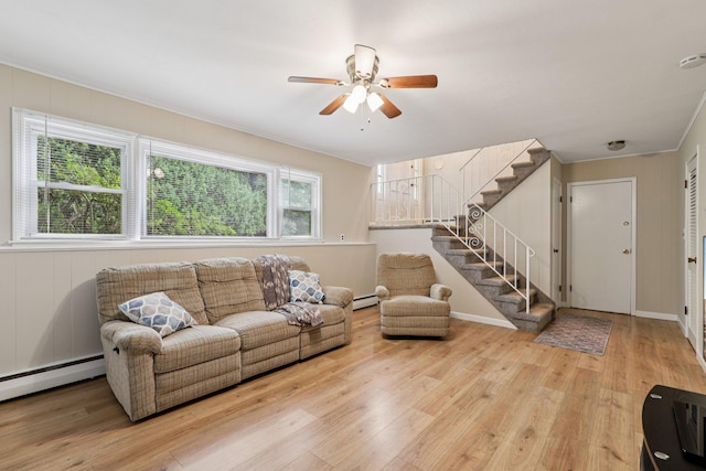 118 Standish Dr, Pearl River, NY 10965 - living area with a baseboard heating unit, a ceiling fan, stairs, and light wood-style flooring