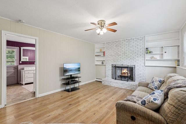 118 Standish Dr, Pearl River, NY 10965 - living room featuring a ceiling fan, a baseboard radiator, wood finished floors, a fireplace, and crown molding