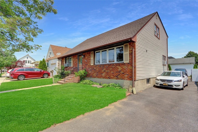 104 S 3rd St, New Hyde Park, NY 11040 - bungalow with roof with shingles, a front lawn, and brick siding