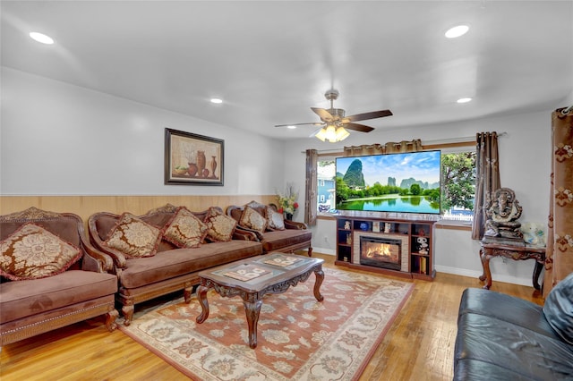 104 S 3rd St, New Hyde Park, NY 11040 - living area featuring recessed lighting, a ceiling fan, wood finished floors, and a glass covered fireplace