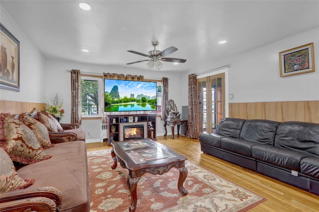 104 S 3rd St, New Hyde Park, NY 11040 - living area featuring french doors, radiator heating unit, wood finished floors, a ceiling fan, and recessed lighting