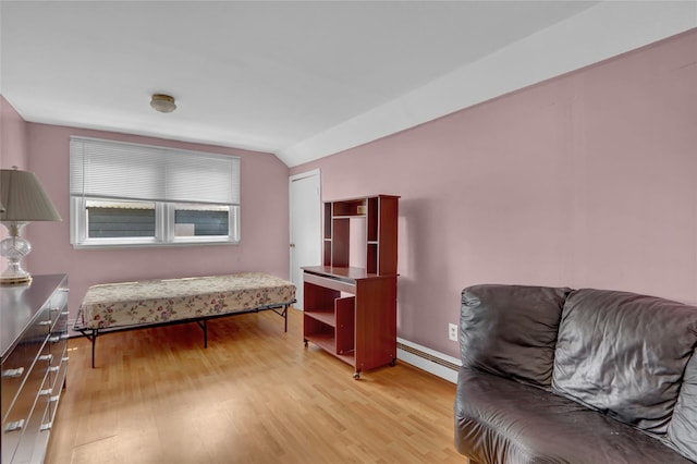 104 S 3rd St, New Hyde Park, NY 11040 - living area featuring a baseboard radiator, light wood-style flooring, and lofted ceiling