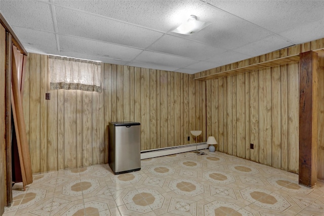 104 S 3rd St, New Hyde Park, NY 11040 - finished basement with a baseboard heating unit, a drop ceiling, and wooden walls