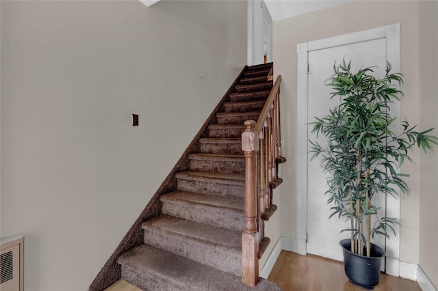 104 S 3rd St, New Hyde Park, NY 11040 - staircase with wood finished floors and baseboards