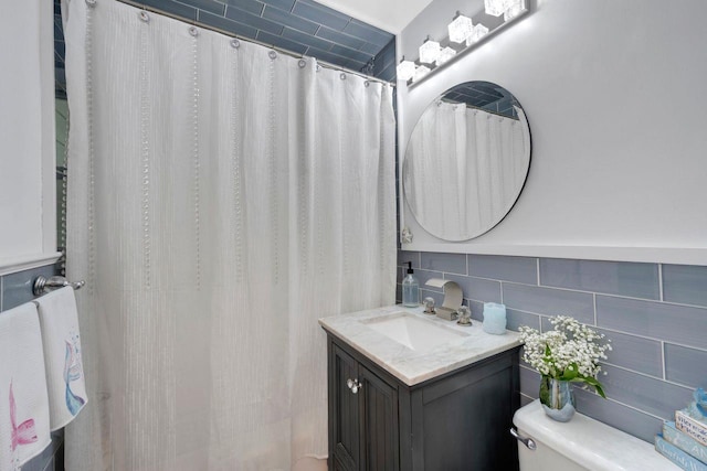 61 Columbus Ave Unit 1B, West Harrison, NY 10604 - bathroom featuring tile walls, vanity, and curtained shower