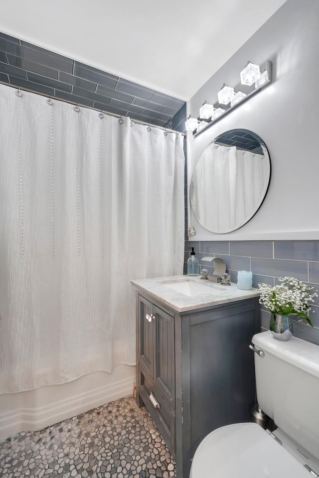 61 Columbus Ave Unit 1B, West Harrison, NY 10604 - bathroom featuring vanity, shower / tub combo with curtain, and tile walls