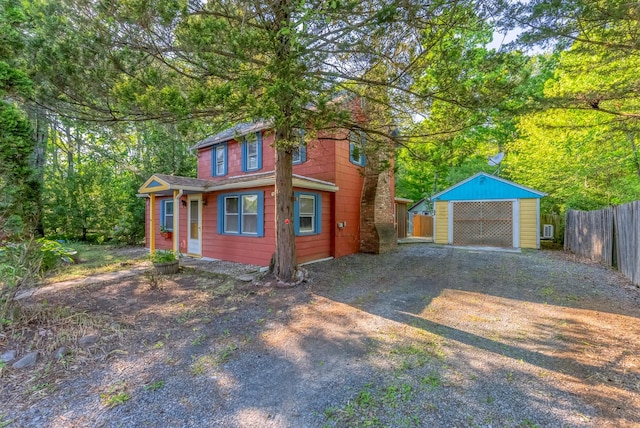 872-874 Rte 212, Saugerties, NY 12477 - view of front facade with dirt driveway, a garage, and an outdoor structure