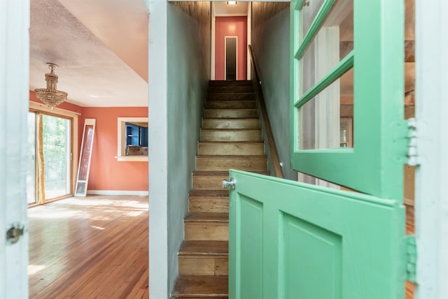 872-874 Rte 212, Saugerties, NY 12477 - staircase featuring a chandelier, wood-type flooring, and baseboards