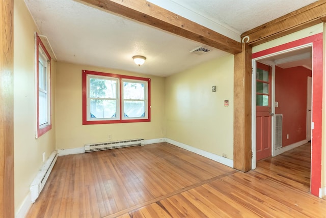872-874 Rte 212, Saugerties, NY 12477 - spare room featuring a baseboard radiator, light wood-style floors, baseboards, and beam ceiling