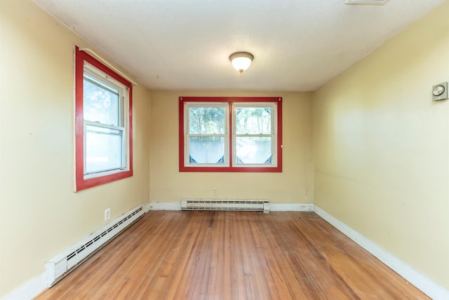 872-874 Rte 212, Saugerties, NY 12477 - empty room with a baseboard heating unit, light wood-style flooring, and baseboards