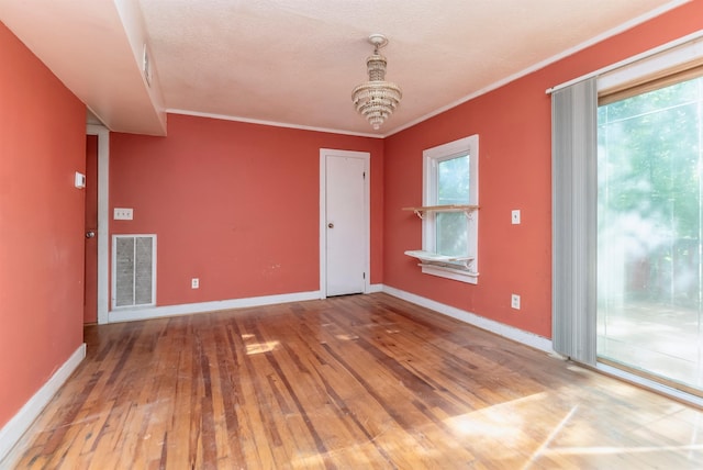 872-874 Rte 212, Saugerties, NY 12477 - unfurnished room with wood-type flooring, ornamental molding, baseboards, a chandelier, and a textured ceiling