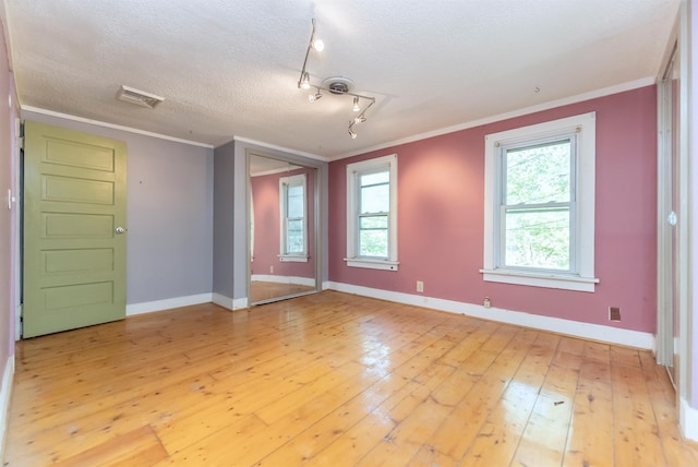872-874 Rte 212, Saugerties, NY 12477 - spare room featuring crown molding, light wood-type flooring, plenty of natural light, baseboards, and a textured ceiling