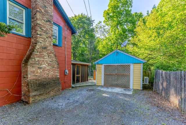 872-874 Rte 212, Saugerties, NY 12477 - view of patio / terrace with gravel driveway, a detached garage, and an outbuilding