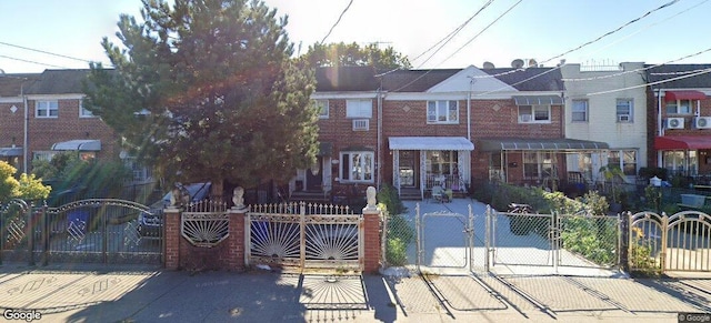 15542 Linden Blvd, Jamaica, NY 11434 - townhome / multi-family property featuring a fenced front yard, a gate, and brick siding